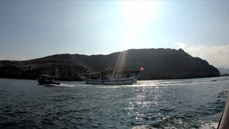 Boats-moving-through-the-sea,-fjords-near-Khasab,-Musandam,-Oman-fjords