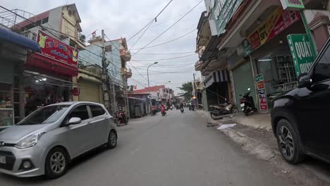 POV-driving-motorbike-in-city-of-Vietnam-on-moody-day