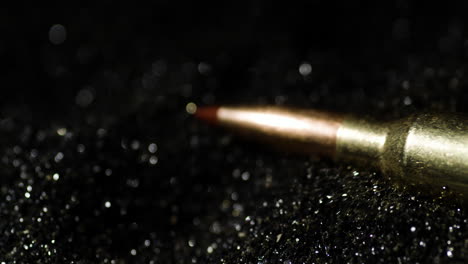 6mm-ARC-Cartridges-Pile-Over-Black-Granules-Of-Bullet-Powder