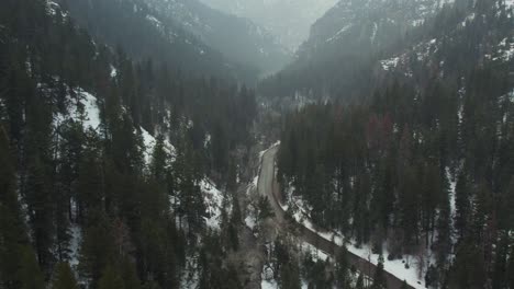 Road-Curving-Through-Canyon-In-Winter---American-Fork-Canyon-In-Utah,-United-States---Drone-Shot