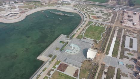 Rajkot-Atal-lake-drone-view-Ashok-Chakra-is-also-visible-around-which-many-big-gardens-and-big-roads-are-visible,-Rajkot-New-Race-Course,-Atal-Sarovar