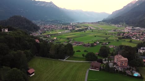 Lauterbrunnen-townscape-and-waterfall-drone-aerial-view-above-swiss-mountains-in-alps