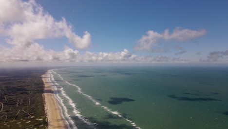 Aerial-view-of-the-coastline-with-waves-and-clouds-of-the-North-Sea-in-Denmark-with-waves-and-clouds