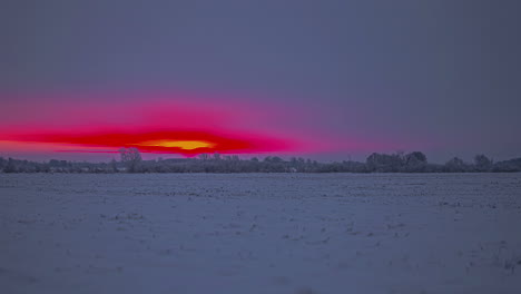 Beautiful-sunset-captured-over-frozen-winter-wonderland-in-time-lapse