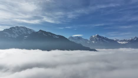 Alpine-Peaks-Above-Sea-of-Fog-at-Walensee,-Switzerland---aerial