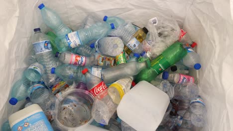 Topdown-view-of-Plastic-bottles-throwing-too-recycling-container,-Timelapse