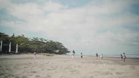 Group-of-People-Walking-Along-a-Beach-at-La-Union,-Philippines