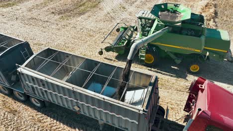 John-Deere-combine-unloading-a-hopper-of-canola-into-a-semi-trailer