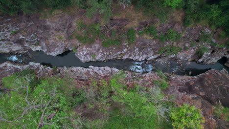 Aerial-shot-of-Cajones-de-Chame,-rocky-canyon-with-flowing-river-in-Panama,-lush-greenery-surrounds