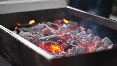 Hot-coals-and-flames-in-a-barbecue-pit