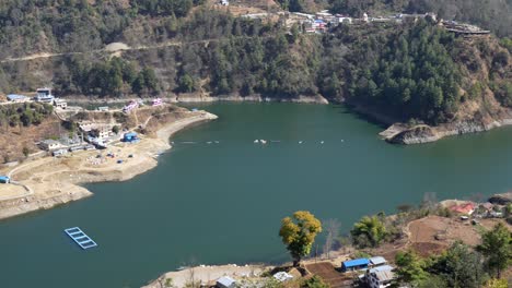 A-high-angle-panning-view-of-Kulekhani-Lake-and-the-small-towns-dotting-the-shoreline-in-Nepal