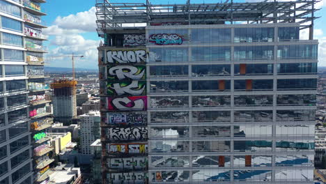 Luftaufnahme-Eines-Mit-Graffiti-Bedeckten-Wolkenkratzers-Im-Sonnigen-Los-Angeles