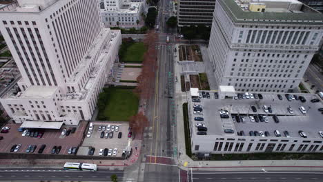 Los-Angeles-CA-USA,-Aerial-View-of-City-Hall,-US-Courthouse,-Hall-of-Justice-and-Downtown-Skyscrapers,-Revealing-Drone-Shot-by-US-101-Interstate-Route-Highway