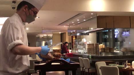 Chef-carves-up-some-duck-in-a-posh-restaurant,-Hong-Kong