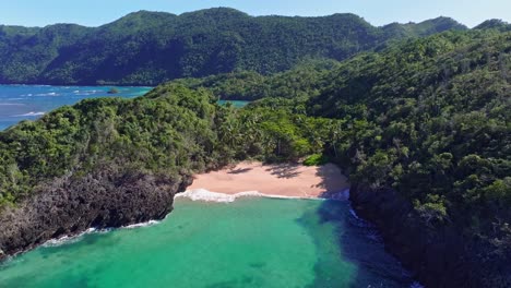 Secluded-pristine-tropical-Caribbean-beach-in-cove-surrounded-by-jungle