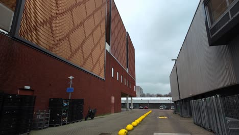 Exterior-of-red-brickstone-warehouse-and-grey-temporary-stockroom-in-Amsterdam-Noord