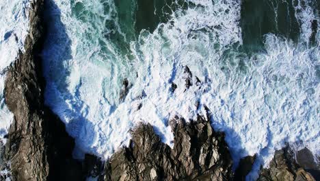 Cornish-Coastline-with-Slow-Motion-Ocean-Waves-from-a-Top-Down-Overhead-Shot