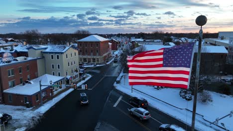 Waving-American-Flag-over-small-American-town-in-winter-season