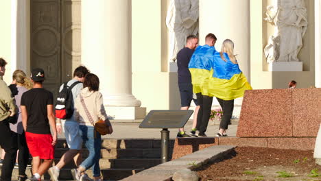 Young-adult-group-wearing-Ukraine-flag-during-Vilnius-NATO-summit-in-the-Lithuanian-capital