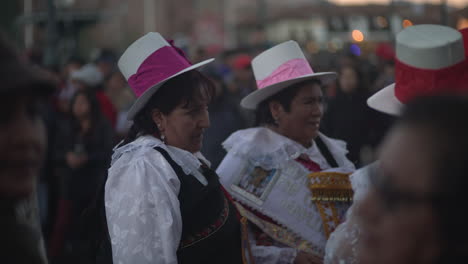 In-Cusco,-Peru,-a-vibrant-religious-celebration-unfolds-for-Nuestra-Señora-de-Fátima,-where-joyfully-adorned-women-and-men,-dressed-in-their-polleras-and-jobona,-parade-through-the-streets