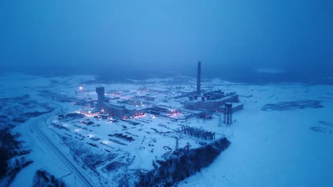 Rising-4K-Drone-Clip-Blue-Hour-Morning-Foggy-Haze-Snowing-Vale-Industrial-Winter-Arctic-Nickel-Coal-Metal-Natural-Resources-Power-Station-Mine-in-Hub-of-North-Northern-Thompson-Manitoba-Canada