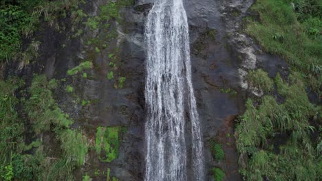 Bonao-Jima-Falls,-water-flowing-over-rocks-in-middle-of-forest