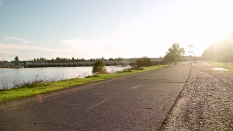 Biker-on-river-path-at-sunset