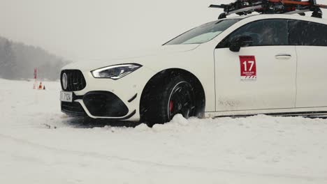 Car-stuck-in-dense-snow-during-snowfall,-winter-drift-event-race-track