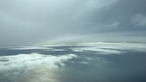 POV-cloudscape-shot-from-an-airplane-flying-across-a-clouded-sky-over-the-sea-in-a-cold-winter-afternoon
