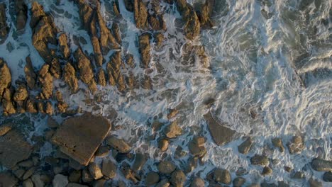 Top-aerial-view-of-waves-crashing-on-the-shoreline-in-Southern-California