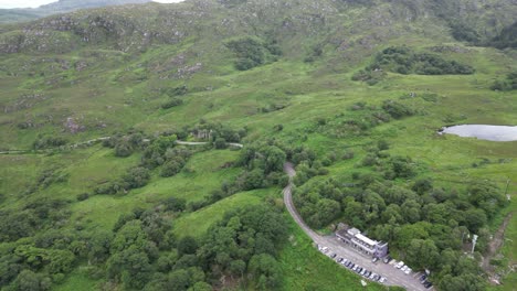 Ladies-view-in-ireland,-showcasing-lush-greenery,-winding-roads,-and-a-serene-lake,-daylight,-tranquil,-aerial-view
