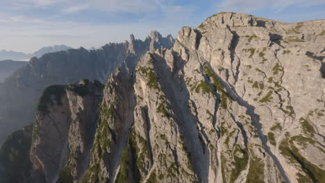 Drone-flying-towards-high-rocky-peaks-of-Dolomites-Mountain-range-in-summer-season