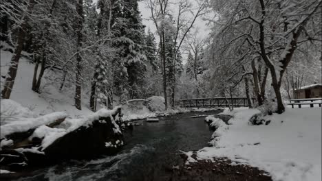 Flying-Under-A-Bridge-In-A-Winter-River-Landscape,-American-Fork-Canyon