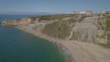 Aerial-dolly-shot-of-the-Miradouro-coast-rock-in-Nazare,-Portugal