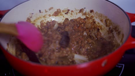 Stirring-a-pot-of-curry-with-chili-peppers-home-made-papaya-curry