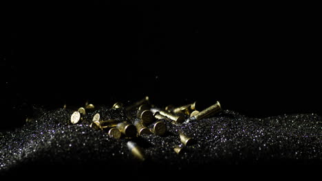 Closeup-Of-22-Long-Rifle-Ammunition-Bullets-Falling-On-Bullet-Grains-In-Slow-Motion