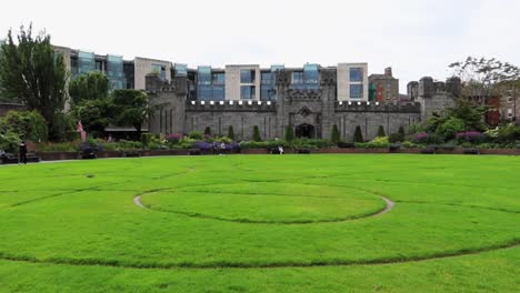 Panoramic-view-of-Dubh-Linn-Garden-next-to-castle-with-a-green-lawn