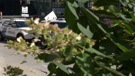 Two-police-cars-parked-on-a-street-in-downtown-Chicago-with-homeland-security-signs-on-the-side