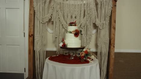 Beautiful-Wedding-Cake-And-Flower-Arrangement-At-Reception