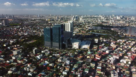 Establishing-drone-shot-orbiting-the-Ayala-Malls-Circuit,-in-Manila,-Philippines