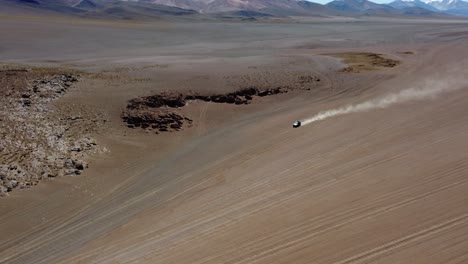 Rotierende-Luftaufnahme:-Einsamer-Touristen-LKW-Fährt-Durch-Riesigen-Wüstensand