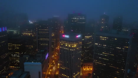 Drone-shot-away-from-the-US-bank-high-rise,-foggy-night-in-San-Francisco,-USA