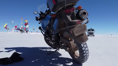 Motorcycle-parked-on-salt-flat-near-Uyuni-Plaza-of-Flags-in-Bolivia