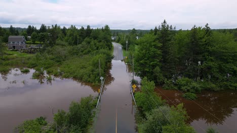 Natural-disaster-river-flooding-closed-road-due-to-bridge-submerged-underwater