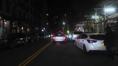 POV-shot-driving-through-streets-of-Manhattan,-winter-night-in-New-York-city,-USA