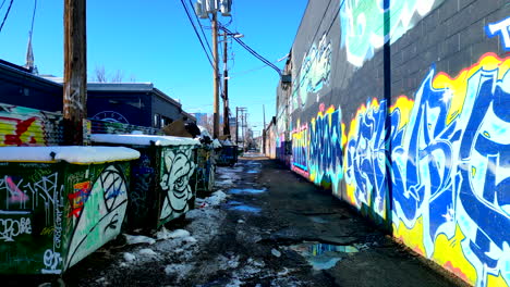 Graffiti-covered-alleyway-in-Denver's-RiNo-art-district-on-a-bright-sunny-winter-day