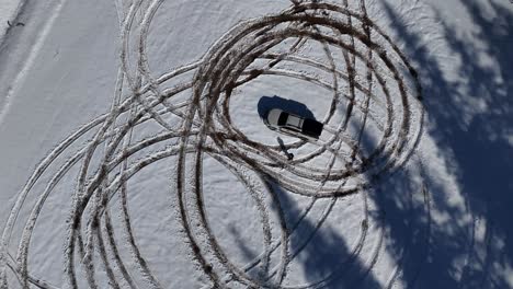 Drone-view-of-suv-car-rotating-around-itself-in-winter-time