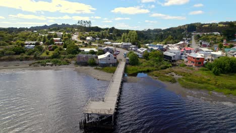 Aerial-Drone-Fly-Above-Bridge,-Small-Village-at-Huillinco-Lake-Chiloé-Chilean-Patagonian-Landscape,-Summer-Skyline-and-Green-Island-Hills