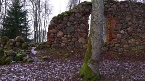 Forgotten-church-boulder-wall-remains-in-gloomy-countryside-forest-environment