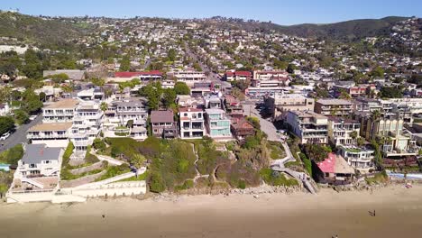 Aerial-View-of-Beautiful-Beachfront-Estates-in-Laguna-Beach,-California-overlooking-the-Pacific-Ocean-on-a-Warm-Sunny-day